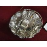 A Mappin & Webb plated cake basket, two serving tongs, two sauceboats and a pair of candlesnuffers