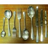 An eight place setting United Cutlers silver cutlery with four serving spoons, four teaspoons and