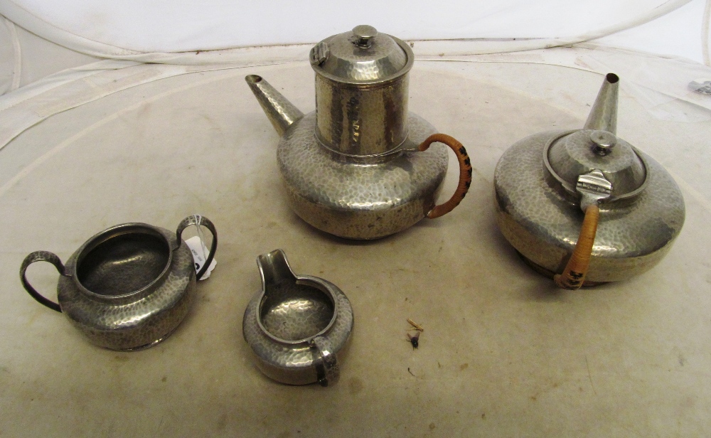 A four piece Lion beaten pewter teaset