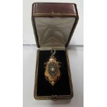 An antique French filigree pendant with central oval flowerhead of diamonds and pearl