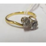 An 18ct two stone diamond crossover ring