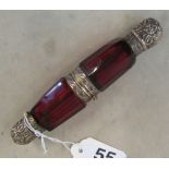 A double ended red glass scent bottle with hinged metal centre and embossed metal ends