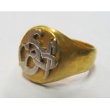 A high grade gold signet ring with silver coloured symbol 7.8gm