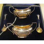 A pair of silver two handled and gadrooned salts and pair of spoons (i.c)