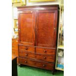 A 19th Century mahogany linen press the two panelled doors opening to reveal trays above two short