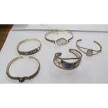 Two Mexican silver bangles and three others