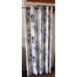 A pair of cream ground curtains with green and pink floral design and a pair of cream curtains