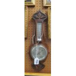 An oak cased barometer/thermometer