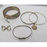 Three silver bangles and pair of earrings