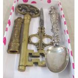 A brass tray, spoon and scissors