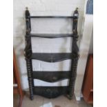 A Regency narrow black lacquer five tier bookshelf decorated flowers