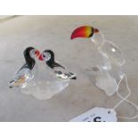 A Swarovski crystal Toucan with coloured beak and a pair of Puffins with coloured beaks