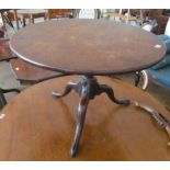 A 19th Century mahogany circular top tip-up action table on tripod supports (pin missing)