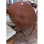 A 19th Century mahogany circular tip-up action table on tripod supports