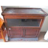 A Globe Wernicke style low bookcase one glazed tier above two cupboard doors