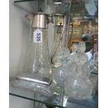 An etched glass claret jug with plated rim, silver topped dressing table pot and three glass scent