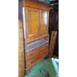 A 19th Century oak linenpress two cupboards doors over three drawers on bracket feet, secretaire