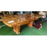 An Art Deco walnut extending dining table on twin pillars and set of six chairs (split back)