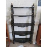 A Regency narrow black lacquer five tier bookshelf decorated flowers