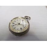 A silver pocket watch with white enamel dial