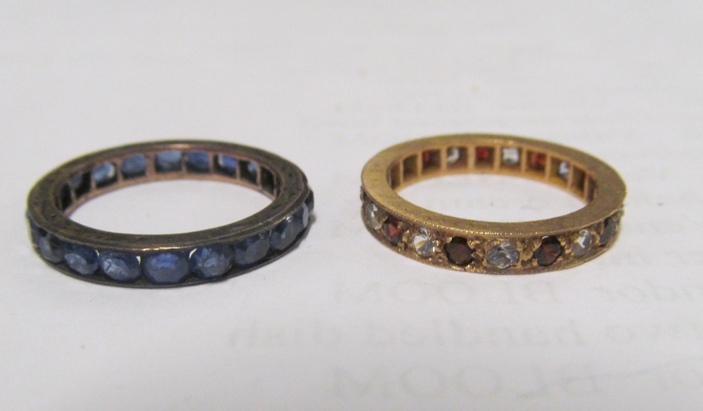 A gold eternity ring set red stones and diamond 2.2g and another eternity ring