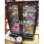 Some model cars in cabinet and two Hummel figures (one a/f)