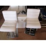 A pair of cream bar chairs
