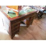 A yew twin pedestal desk and a similar small chest of four drawers