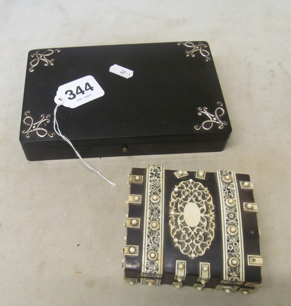 An ebony games box with silver mounts and ebony and ivory (?) box with ivory counters