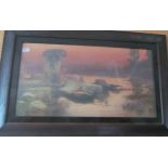 A large print sunset over river in oak frame