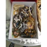 A box of gemstone and pearl bracelets