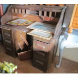 An oak roll top pedestal desk