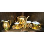 A Royal Worcester gold teapot and other gold coloured china