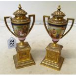 A pair French ormolu and porcelain urns on stands