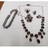 A set of Indian garnet jewellery:- bracelet, necklace, earrings, ring, necklace and flower brooch