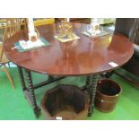 A large mahogany gate leg table on bobbin turned support