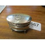 A small silver box on four legs