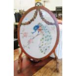A painted satinwood oval firescreen with period embroidery