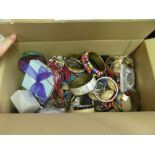 A box of costume bangles and earrings