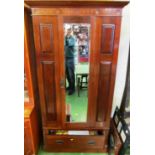 A mahogany wardrobe with bevelled glass door