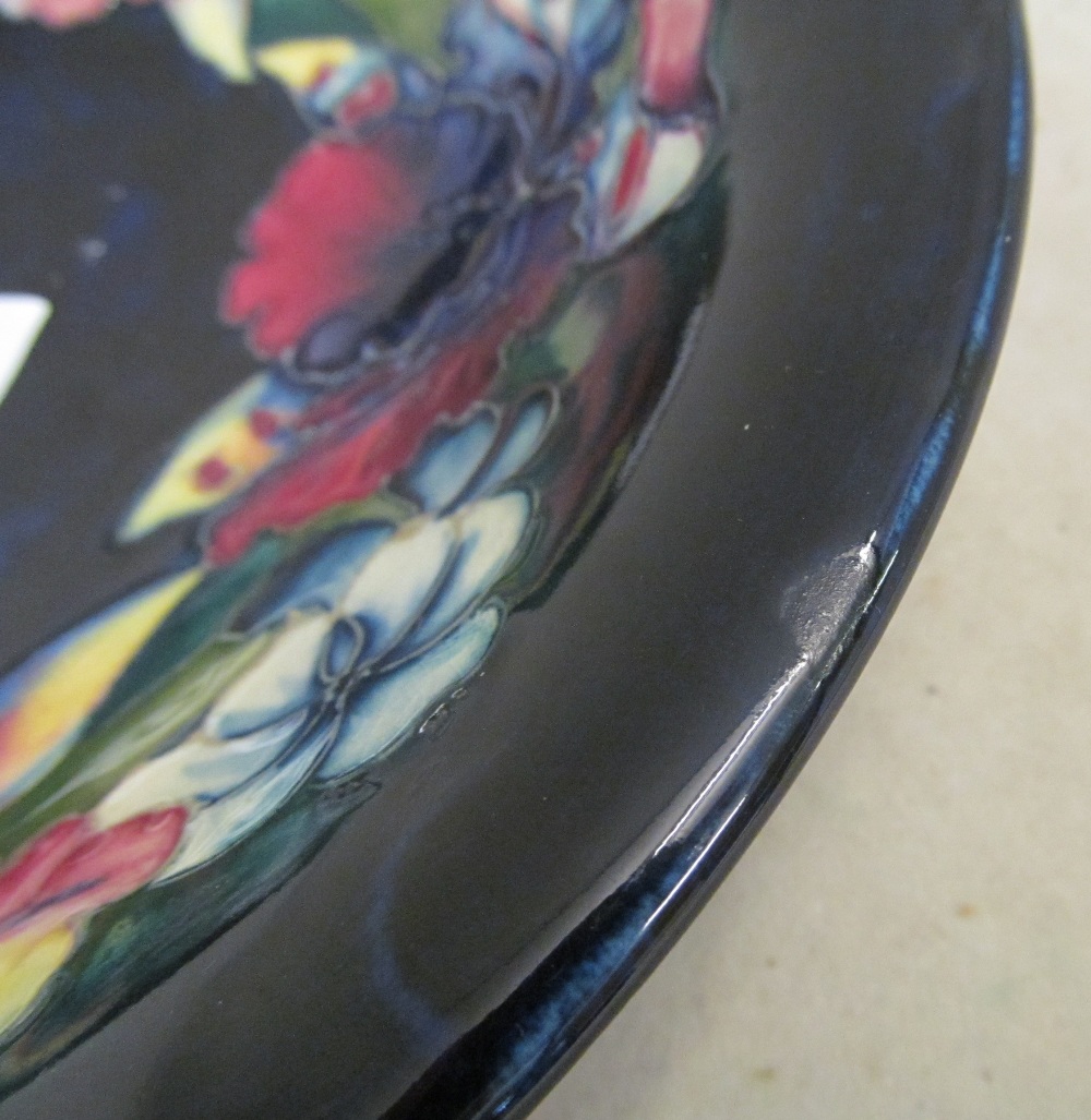 A Moorcroft dark blue glazed bowl decorated pink and blue flowers - Image 2 of 3