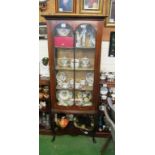 An Edwardian inlaid mahogany cabinet on cabriole legs