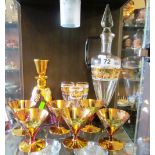 A Venetian red and gilt floral liqueur decanter and six glasses, tall decanter and three glasses