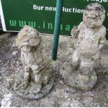 A concrete garden cricketer and boy with hat