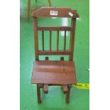 A folding oak mothering chair