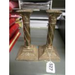 A pair of Corinthian column candlesticks with wreath bases