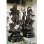 A pair of spelter cherub table lamps on circular bases