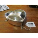 A large silver heart shaped box