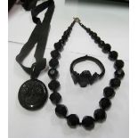 A Victorian jet carved rose design hair locket, black bead necklace and a bracelet