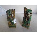 A pair of 19th Century pottery joss stick holders in the form of kylin lions
